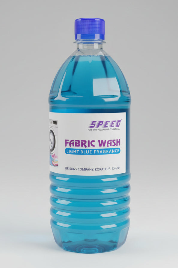 Clear plastic bottle filled with bright blue liquid fabric wash, labeled "SPEED PLUS FABRIC WASH - LIGHT BLUE FRAGRANCE".